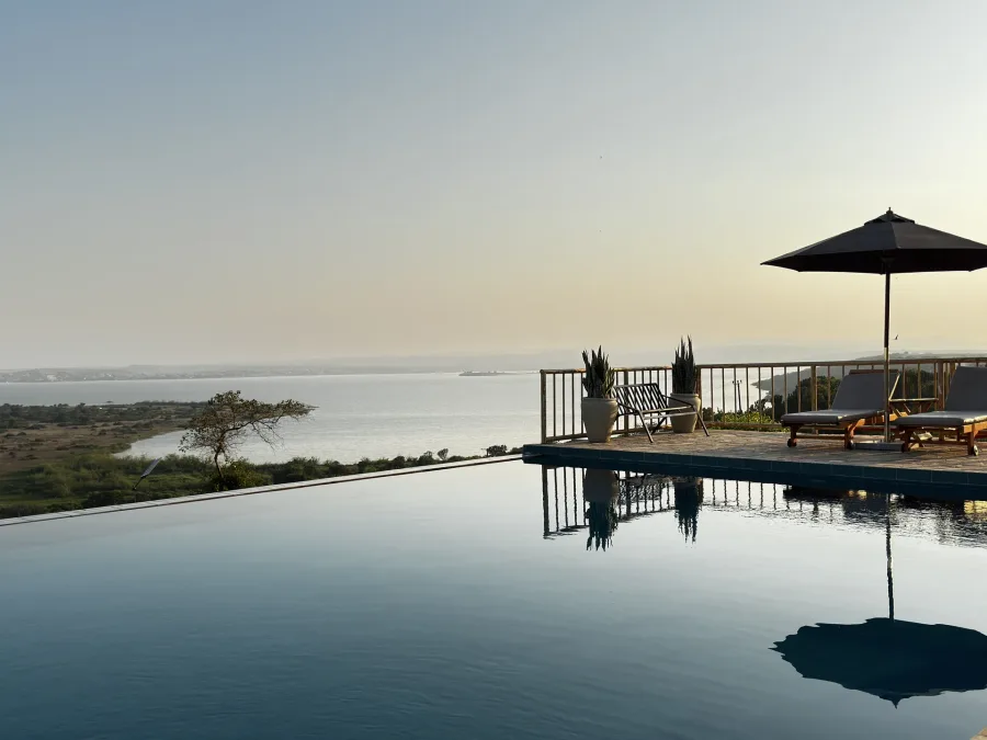 An infinity pool overlooking the lake at sunset on the 12 Days Uganda Wildlife & Primate Safari