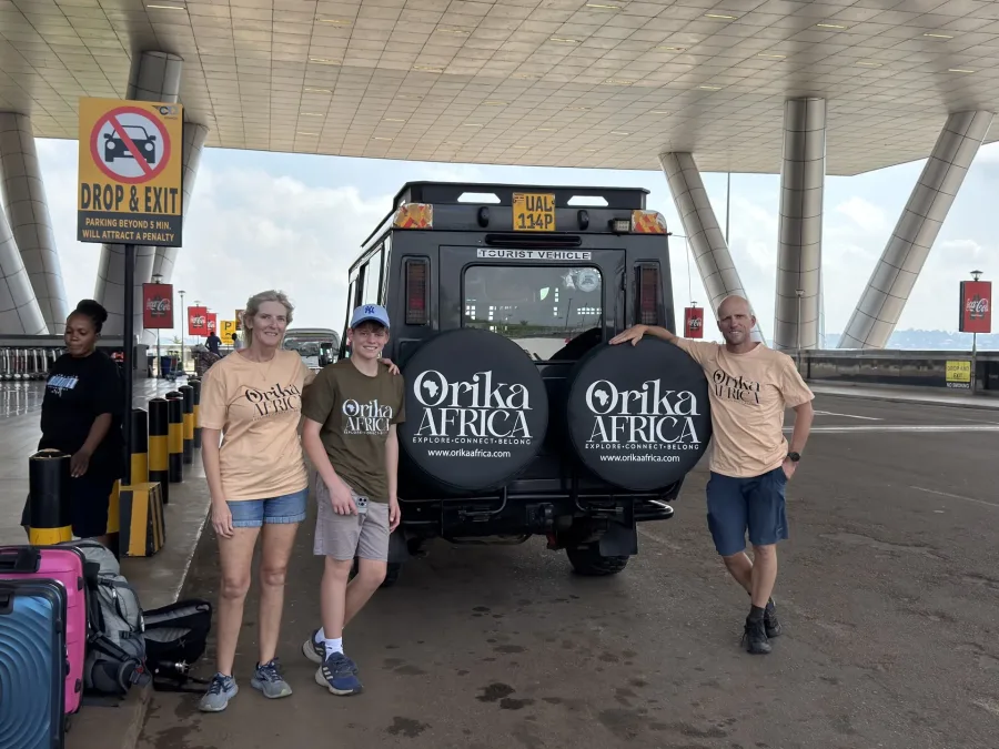 Guests with an Orika Africa safari vehicle at Entebbe Airport on the 5 Days Murchison Falls & Budongo Safari
